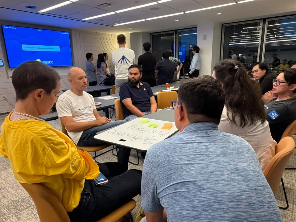 People discussing software workflows at a SuperPlane workshop